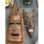 A PAIR OF DECORATIVE WOODEN TRIBAL MASKS