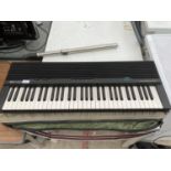 A YAMAHA KEYBOARD WITH CARRY CASE AND STAND