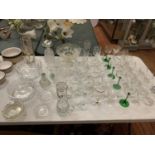 A LARGE QUANTITY OF GLASSWARE TO INCLUDE GREEN STEMMED WINE GLASSES AND SEVERAL BOWLS