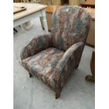 A 1940s ARMCHAIR ON OAK SUPPORTS WITH CASTERS