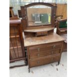 AN OAK DRESSING TABLE WITH THREE LOWER DRAWERS, SMALL UPPER DRAWER AND BEVEL EDGE MIRROR