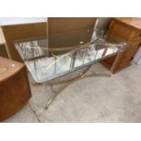 A MODERN GLASS TOPPED COFFEE TABLE ON BRASS BASE WITH CLEAR PLASTIC LEGS, 47x24"