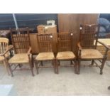 FOUR LANCASHIRE ELM SPINDLE BACK DINING CHAIRS WITH RUSH SEATS TO INCLUDE TWO CARVERS