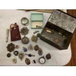 A TIN BOX CONTAINING MILITARY BADGES, SILVER WATCH, GILT ENAMEL BADGES ETC