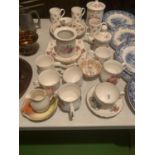 A LARGE ASSORTMENT OF CERAMIC WARE TO INCLUDE CUPS AND SAUCERS ETC