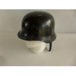 A BLACK PAINTED FIBREGLASS GERMAN HELMET