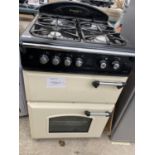 A CREAM AND BLACK LEISURE FREE STANDING HOB, GRILL AND OVEN BELIEVED IN WORKING ORDER BUT NO