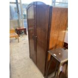 AN OAK TWO DOOR WARDROBE