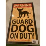 A METAL 'WARNING GUARD DOG ON DUTY' SIGN
