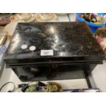 A LARGE BLACK METAL DEED BOX