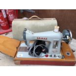 A VINTAGE JONES MODEL CBD CASED ELECTRIC SEWING MACHINE