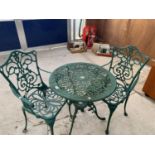 AN ORNATE METAL GARDEN BISTRO SET OF A TABLE AND TWO CHAIRS