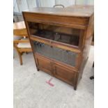 AN EARLY 20TH CENTURY GLOBE WERNIKE STYLE THREE TIER BOOKCASE, WITH CLEAR GLASS TOP SECTION,