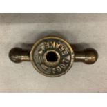 A BRASS FOOT BRAKE KNOB FROM A VINTAGE VEHICLE
