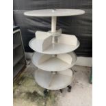 A CIRCULAR METAL SHOP STAND