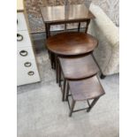 AN EARLY 20TH CENTURY NEST OF THREE OAK TABLES AND AN OAK MAGAZINE RACK/TABLE