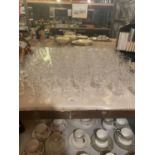 A LARGE QUANTITY OF CUT GLASS WARE TO INCLUDE SHERRY GLASSES AND WINE GLASSES ETC