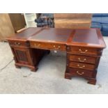 A GEORGIAN STYLE TWIN PEDESTAL PARTNERS DESK ENCLOSING TWELVE DRAWERS AND TWO CUPBOARDS, WITH