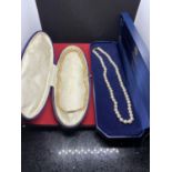 TWO STRINGS OF PEARLS IN PRESENTATION BOXES