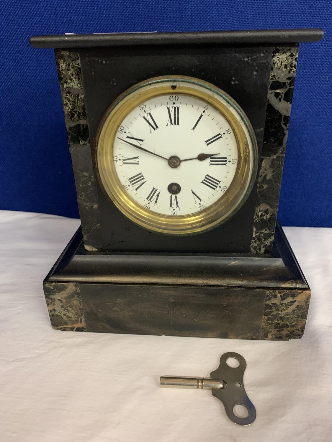 A BLACK MARBLE MANTEL CLOCK