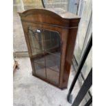 A REPRODUCTION MAHOGANY CORNER CUPBOARD WITH GLAZED DOORS