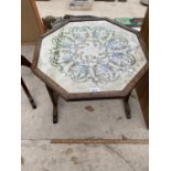 AN OAK AND TAPESTRY TILT TOP OCCASIONAL TABLE
