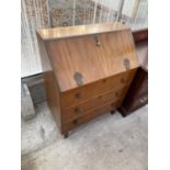 A MID 20TH CENTURY WALNUT FALL FRONT BUREAU WITH THREE DRAWERS