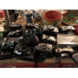 A LARGE COLLECTION OF VARIOUS CAMERAS AND LENSES WITH CASES