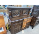 AN ELM COURT CUPBOARD WITH TWO LOWER DOORS AND DRAWERS AND TWO UPPER LEAD GLAZED DOOR