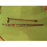A CARVED WOODEN WALKING STICK FEATURING A CAT HANDLE AND A WOODEN SNAKE HANDLE WALKING STICK WITH