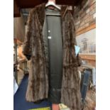 A VINTAGE THREE QUARTER LENGTH FUR COAT WITH HAND STITCHED BESPOKE SATIN INNER LINING AND SLEEVES TO
