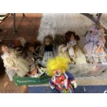 A BOX CONTAINING EIGHT PORCELAIN DOLLS TO INCLUDE A CLOWN ETC