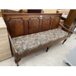 A 19TH CENTURY OAK SETTLE WITH FOUR SECTION PANELED BACK