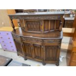 A PRIORY STYLE OAK COURT CUPBOARD WITH FOUR LOWER DOORS AND A ONE UPPER DOOR