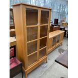 A BEECH CABINET WITH TWO GLAZED PANEL DOORS