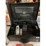 A VINTAGE MOBILE BARBERS CASE CONTAINING HAIRDRESSERS ACCESSORIES