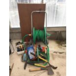 A HOSE REEL AND VARIOUS GARDEN TOOLS