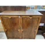 AN OAK CABINET WITH TWO DOORS AND INNER SHELVING