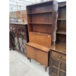 A RETRO TEAK LOUNGE UNIT ENCLOSING DROP-DOWN BUREAU SECTION, CUPBOARD TO BASE AND SHELVES, 32" WIDE