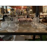 A LARGE QUANTITY OF GLASSWARE TO INCLUDE FOUR DECANTERS AND SIX SERVING PLATES ETC
