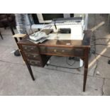 A SINGER ELECTRIC SEWING MACHINE IN AN OAK CABINET