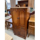 A YEW CABINET WITH TWO UPPER AND TWO LOWER DOORS AND TWO DRAWERS