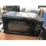 A BLACK PANASONIC MICROWAVE BELIEVED IN WORKING ORDER BUT NO WARRANTY