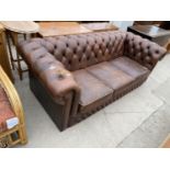 A BROWN LEATHER CHESTERFIELD THREE SEATER SETTEE