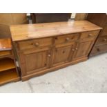 A PINE SIDEBOARD WITH THREE DOORS AND THREE DRAWERS