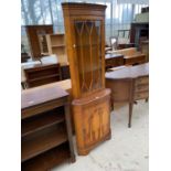 A MAHOGANY CORNER CABINET WITH LOWER DOOR AND UPPER GLAZED PANEL DOOR