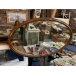 A WOODEN FRAMED OVAL LANDSCAPE ORIENTATED MIRROR