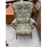 AN ERCOL COMB BACK FIRESIDE CHAIR WITH DETACHABLE SEAT AND BACK CUSHIONS