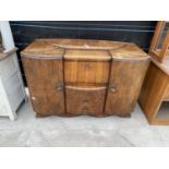 A SHINY WALNUT EXELOAK SIDEBOARD ENCLOSING A LIFT-UP COCKTAIL SECTION, 55" WIDE