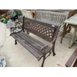 A WOODEN GARDEN BENCH WITH CAST IRON ENDS AND LATTICED BACK AND A FURTHER WOODEN GARDEN BENCH